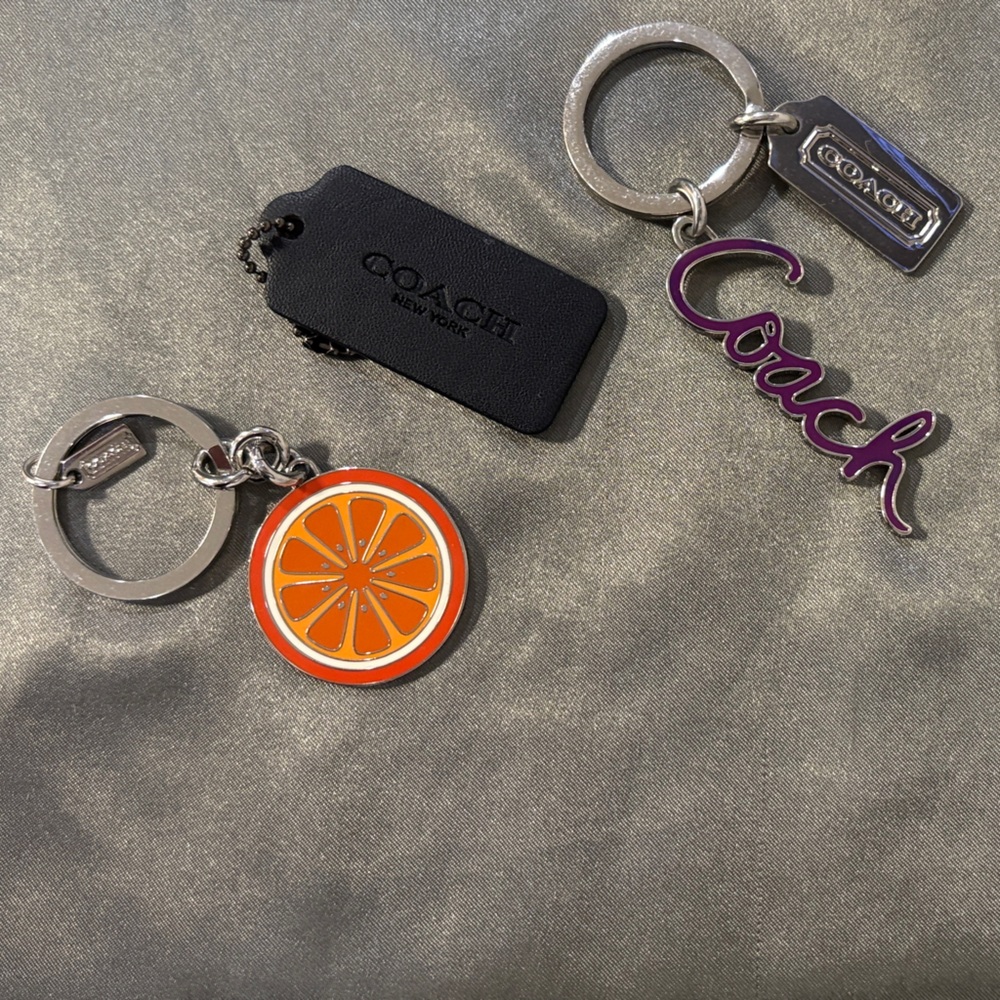 Coach Keychain Set with Orange Slice and Purple Script and black leather tag.